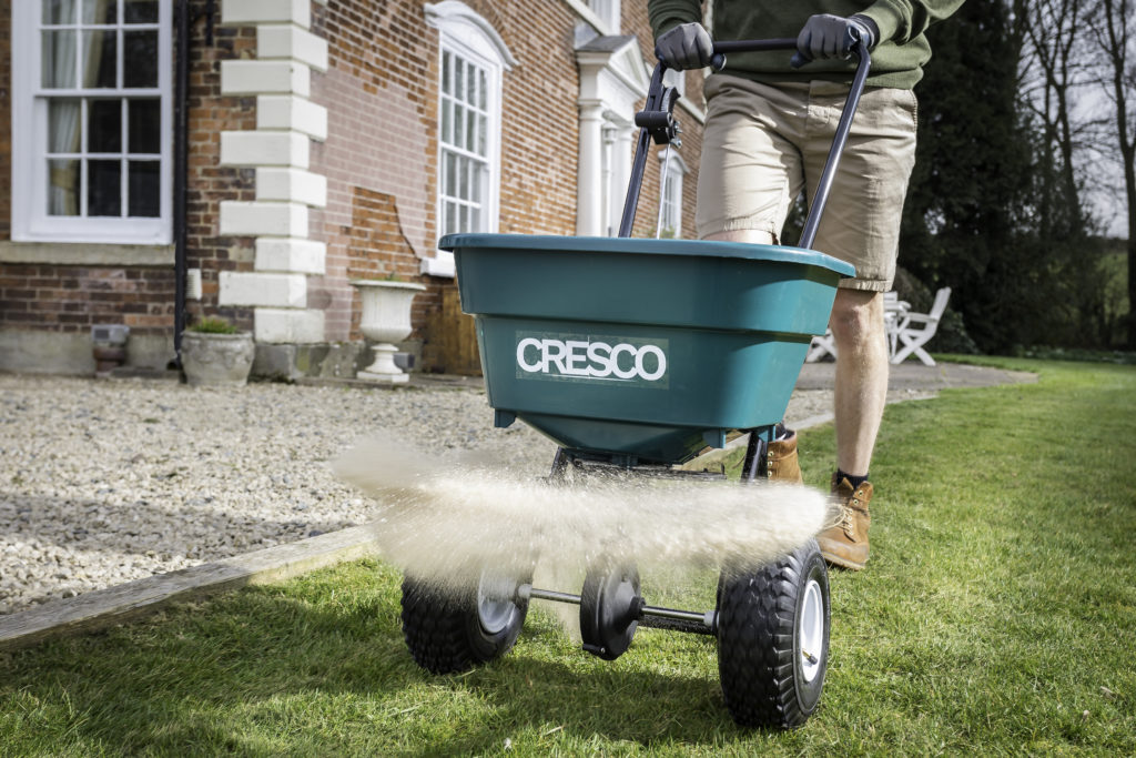 A Cresco 20 spreading fertiliser next to a path