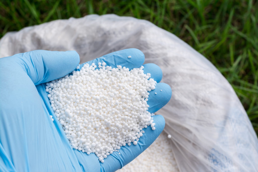 Getting fertilizer out of a bag using gloves